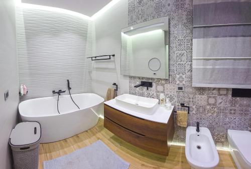 a bathroom with a tub and a toilet and a sink at Luxury Terraced Seaview Apartment, Marina Harbour, Msida, Pieta, Malta in Tal-Pietà