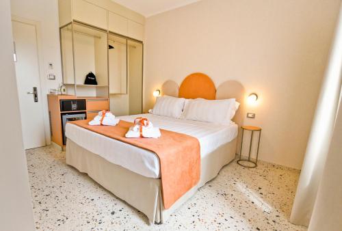 a hotel room with a large bed with towels on it at Maison Boutique Al Redentore in Venice