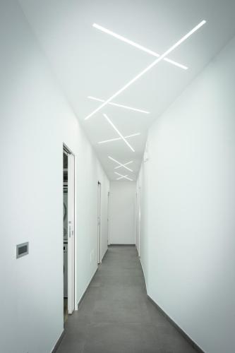 an empty corridor of an office building with white walls and a long hallway at Luxury Terraced Seaview Apartment, Marina Harbour, Msida, Pieta, Malta in Tal-Pietà