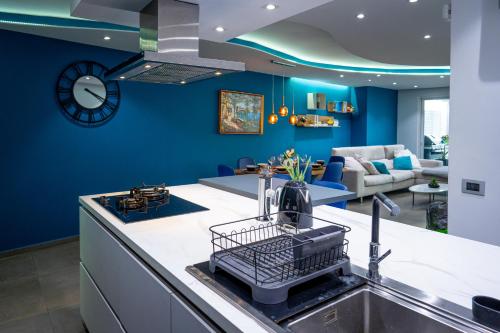 a kitchen with blue walls and a kitchen sink at Luxury Terraced Seaview Apartment, Marina Harbour, Msida, Pieta, Malta in Tal-Pietà