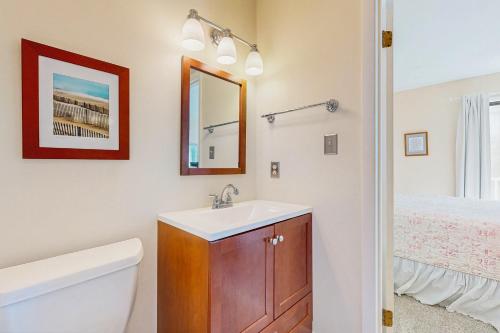 a bathroom with a sink and a toilet and a mirror at Town of Bethany Beach --- 417 Lekites Ave in Bethany Beach