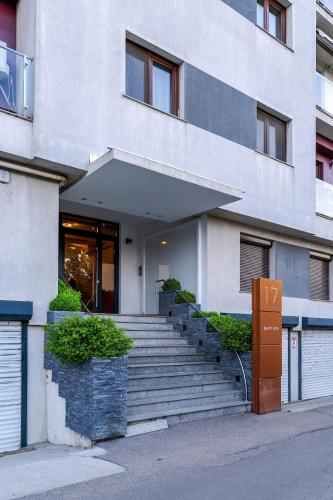 a building with stairs in front of a building at Downtown Floreasca Penthouse with Jacuzzi&Sauna in Bucharest
