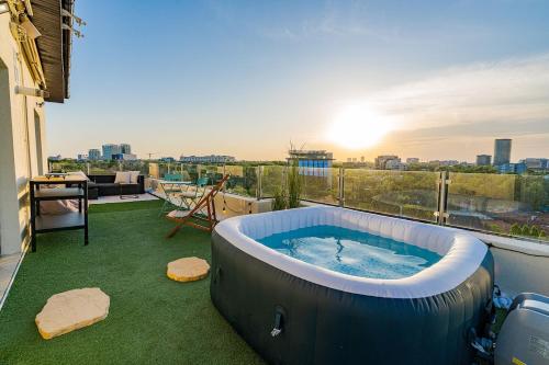 a hot tub on the balcony of a house at Downtown Floreasca Penthouse with Jacuzzi&Sauna in Bucharest