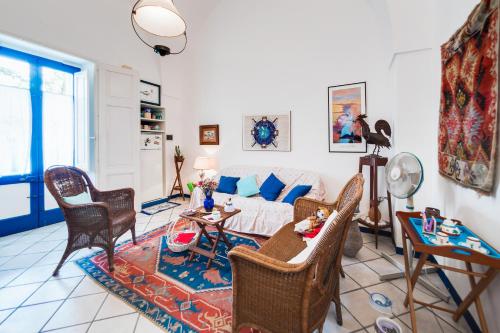 a living room with a couch and chairs at Casa Fiammetta in Leuca