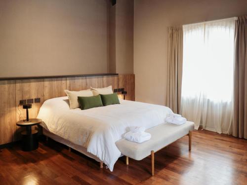 a bedroom with a large white bed and a window at Casa Toledo in La Cumbre