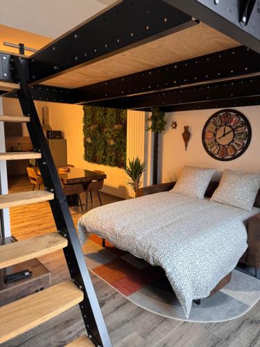 a bedroom with a loft bed with a clock on the wall at Brooklyn Loft - centre parking privé in Troyes