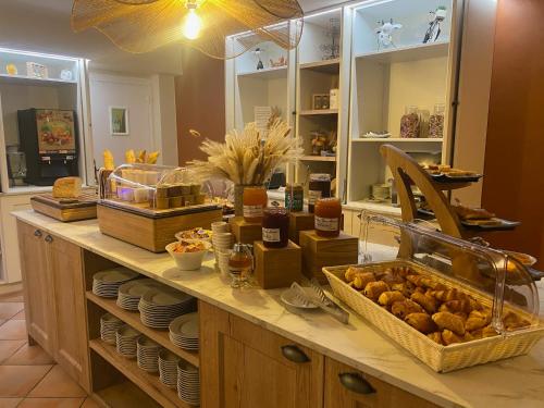 a kitchen with a counter with food on it at Logis Hôtels - Hôtel Restaurant Domaine Les Falaises in Martel
