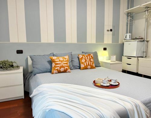 a bedroom with a bed with a tray of food on it at Holihome - La Suite dei Fiori in San Benedetto del Tronto
