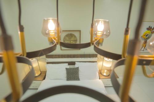 a small room with a bed and lights on it at Accra Luxury Apartments @ Silicon Square in Accra