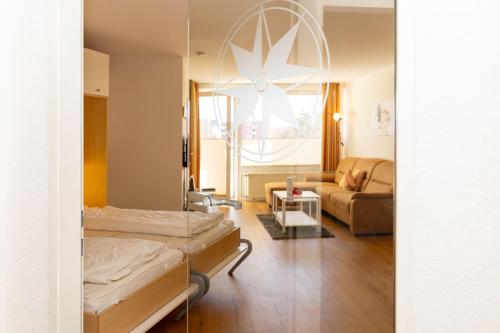 a living room with a bed and a couch at Lord Nelson 115 in Döse