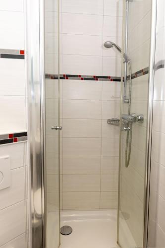 a shower with a glass door in a bathroom at Lord Nelson 115 in Döse