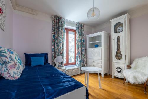 une chambre avec un lit bleu et une fenêtre dans l'établissement Heart of Montmartre Air conditioned apartment, à Paris