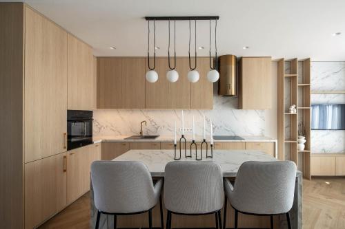 a kitchen with a table and chairs in a room at B-House in Palanga