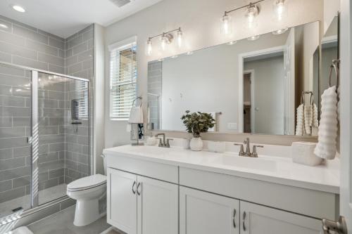 a bathroom with a sink and a toilet and a mirror at The Arizona Hideaway in Gold Canyon