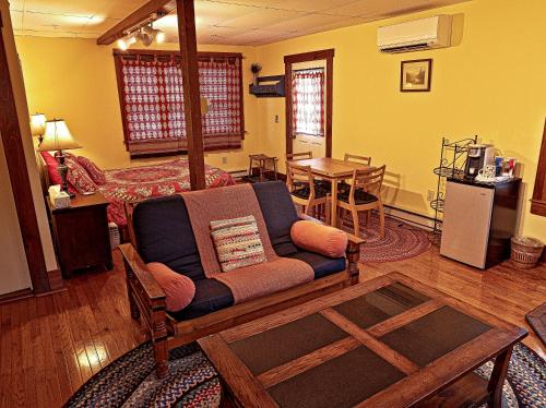 a living room with a couch and a table at The Notch Hostel in North Woodstock