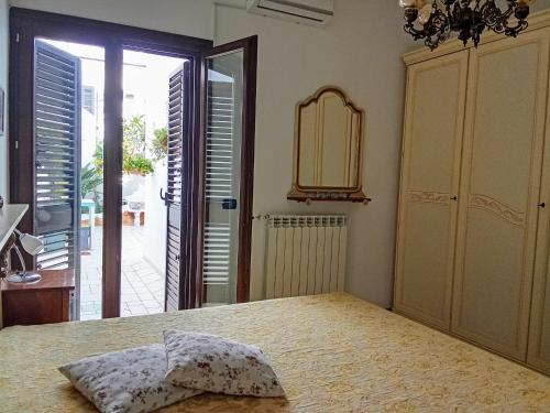 a bedroom with a bed and a door to a balcony at La Rosa Blu in Copertino
