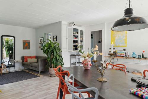 a kitchen and living room with a table and chairs at A Peaceful Oasis Near The Beach And Forest in Hundested