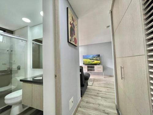 a bathroom with a toilet and a sink at New Cozy and Modern Gym Coworking Terrace in Bogotá