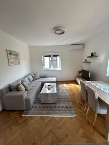 a living room with a couch and a table at Apartman Stević in Vrnjci