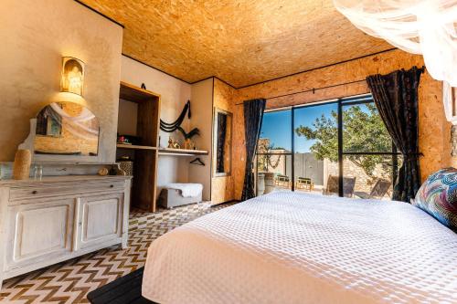 a bedroom with a bed and a large window at Ali Baba Infinity in Essaouira