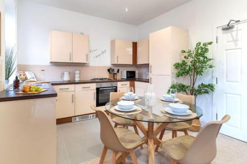 a kitchen with a table and chairs in a kitchen at Balfour House in Etruria