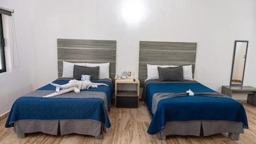 a bedroom with two beds with stuffed animals on them at Splash Inn Nuevo Vallarta & Parque Acuatico in Nuevo Vallarta 