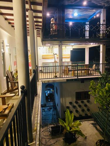 a person sitting on a balcony in a building at Handiranwila Jay Resort in Anguruwatota
