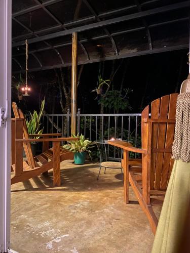 a patio with chairs and a table and a bench at Handiranwila Jay Resort in Anguruwatota