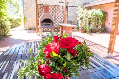 a bouquet of red roses sitting on a table at Fattoria dei Piani srl in Olmedo