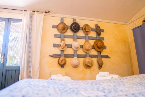 a wall with wooden utensils hanging on a wall at Fattoria dei Piani srl in Olmedo
