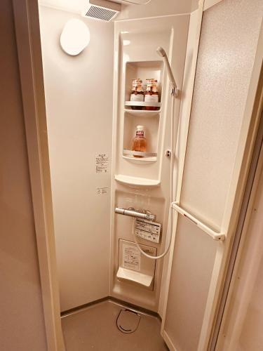 a refrigerator with its door open in a room at 阿久津ハイツ102 in Tokyo