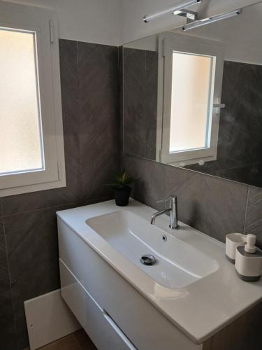 a bathroom with a white sink and a mirror at Esse & Emme in Palermo