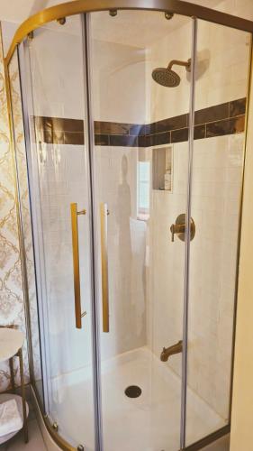 a shower with a glass door in a bathroom at Historic Wilson-Guy House in Niagara on the Lake