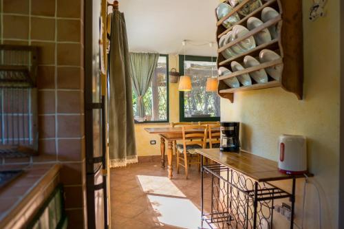 a kitchen with a table and chairs in a room at Fattoria dei Piani srl in Olmedo