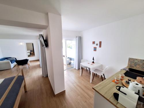 a white apartment with a kitchen and a living room at Romantik Villa in Salema