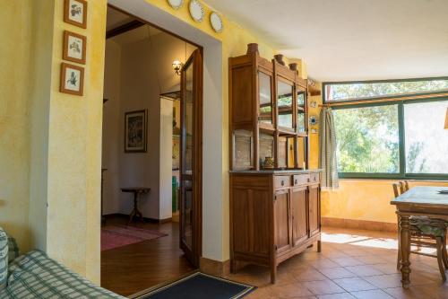 a living room with a wooden cabinet and a mirror at Fattoria dei Piani srl in Olmedo