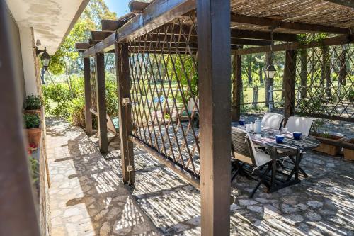 a pergola with a table and chairs on a patio at Fattoria dei Piani srl in Olmedo