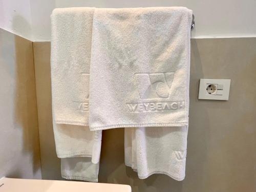 a towel hanging on a wall in a bathroom at Weybeach1 -shared terrace,ocean view,sea frontline in La Santa