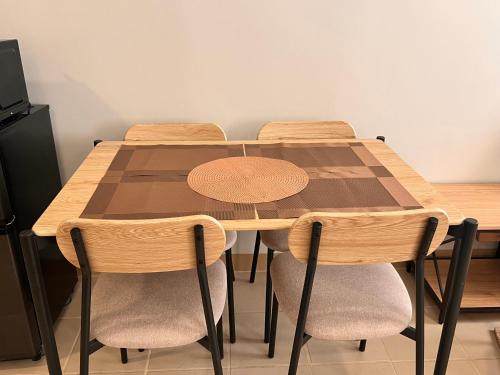 a dining room table with four chairs and a wooden table at The Spot in Marilao