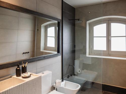 a bathroom with a sink and a toilet and a mirror at Casa Toledo in La Cumbre