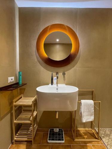 a bathroom with a sink and a mirror on the wall at Stefania Guest House in Giba