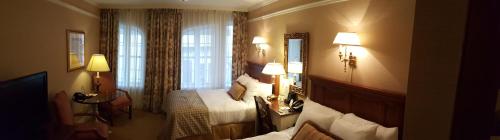 a hotel room with a bed and a window at The Wall Street Inn in New York