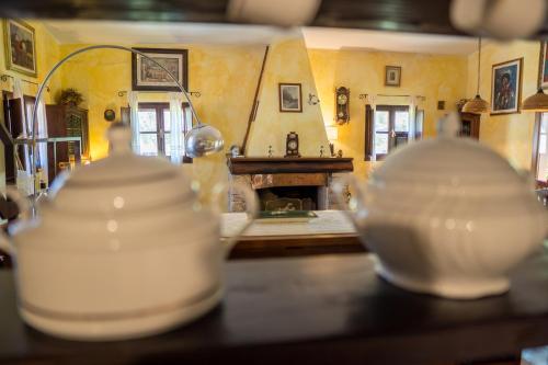 a living room with a fireplace and a table with dishes at Fattoria dei Piani srl in Olmedo