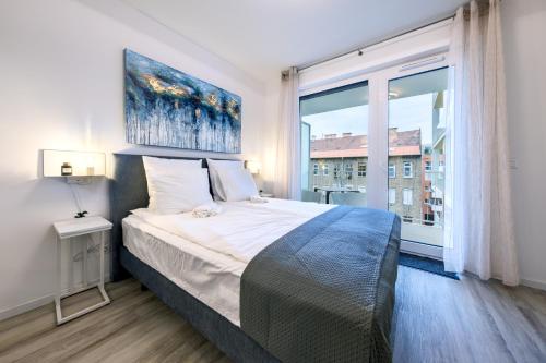 a bedroom with a large bed and a large window at Frankie's Apartment - Free parking in Budapest