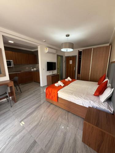 a bedroom with a large bed with red pillows at The Urban Suites in Il-Gżira