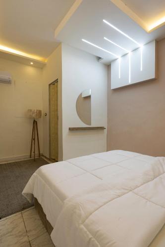 a bedroom with a large white bed in a room at Alex Rooms in Alexandria