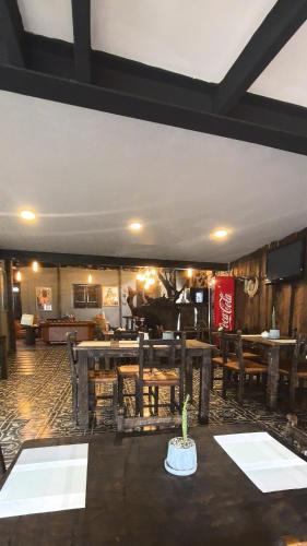 a dining room with tables and chairs and a room at Hotel Quinta Bolivar in Bogotá