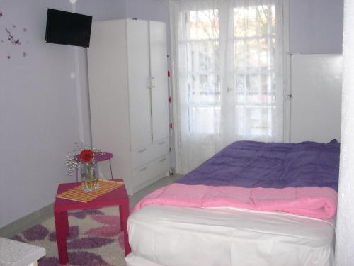 a bedroom with a bed and a table with a night stand at Ormos View Apartments in Ormos Panagias