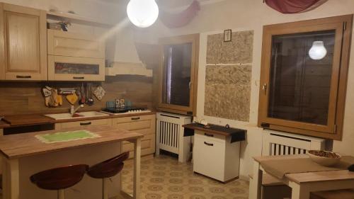 a kitchen with wooden cabinets and a table in it at Private house in Baone