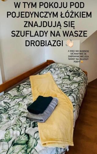 a poster of a bed in a room at Apartamenty u Chlipały in Krośnica